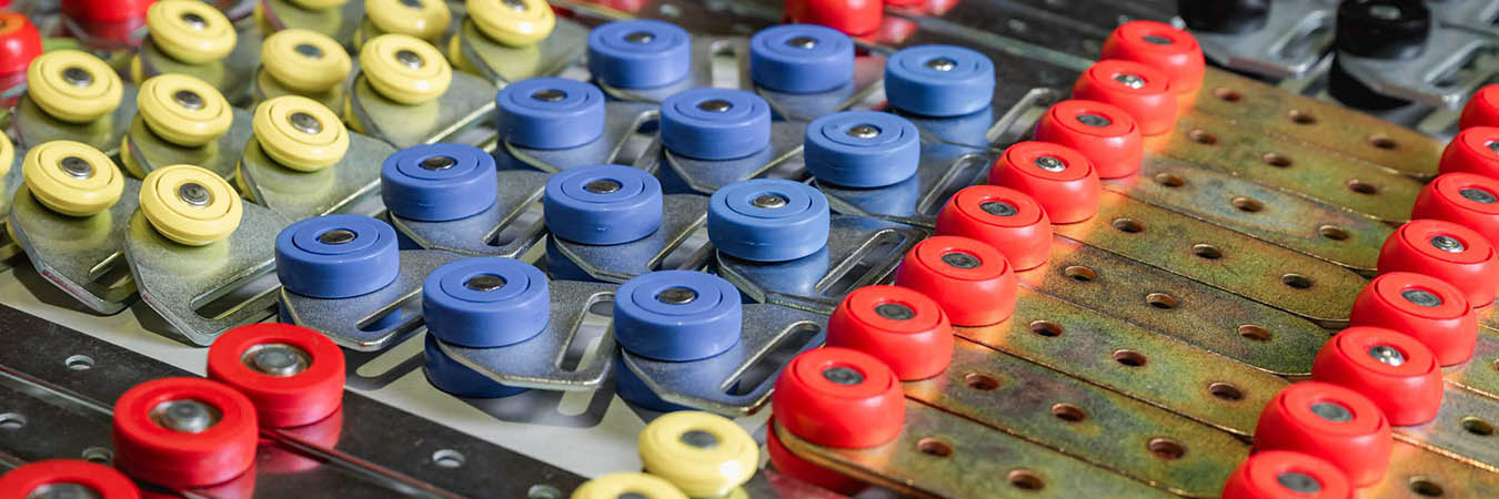 a close-up image of a group of red rollers used for curtainsiders