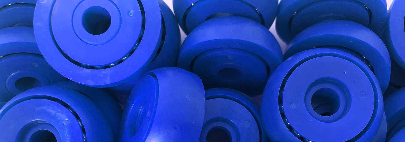 a close-up image of a group of blue bobbins used for curtainsiders