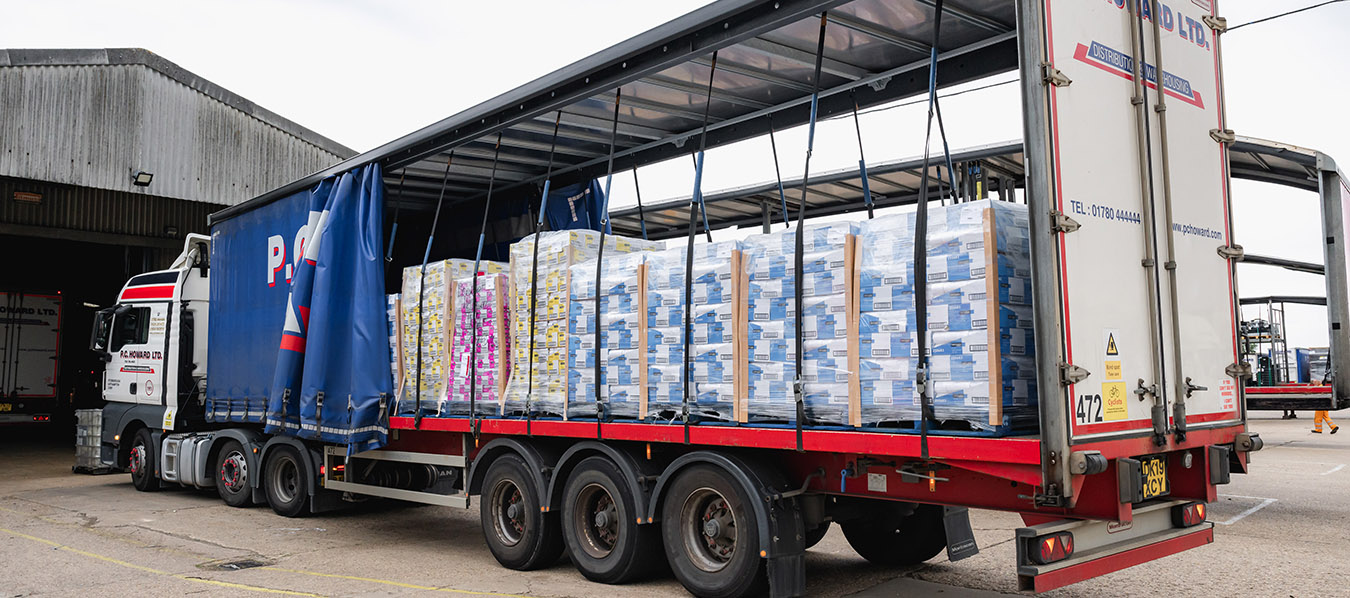 a line of large blue trailers waiting to be attached to lorries