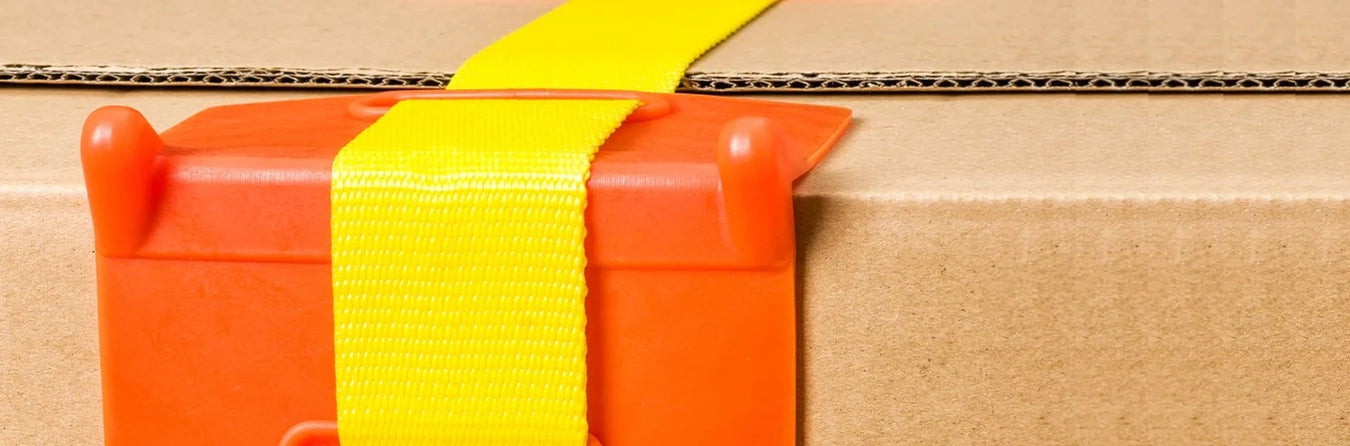 Yellow ratchet strap on the edge of a box